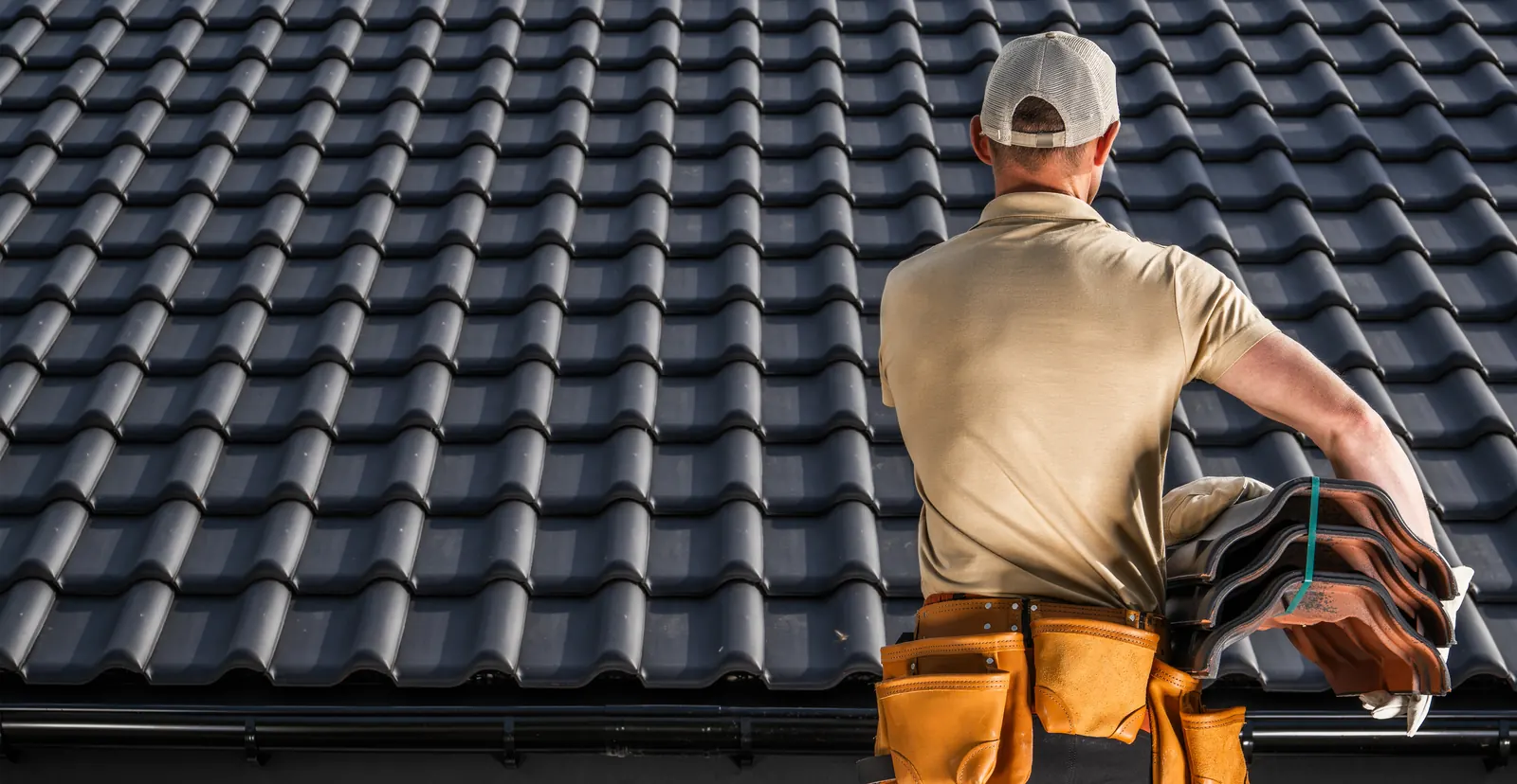 Roofer on a tile roof responding to an emergency repair