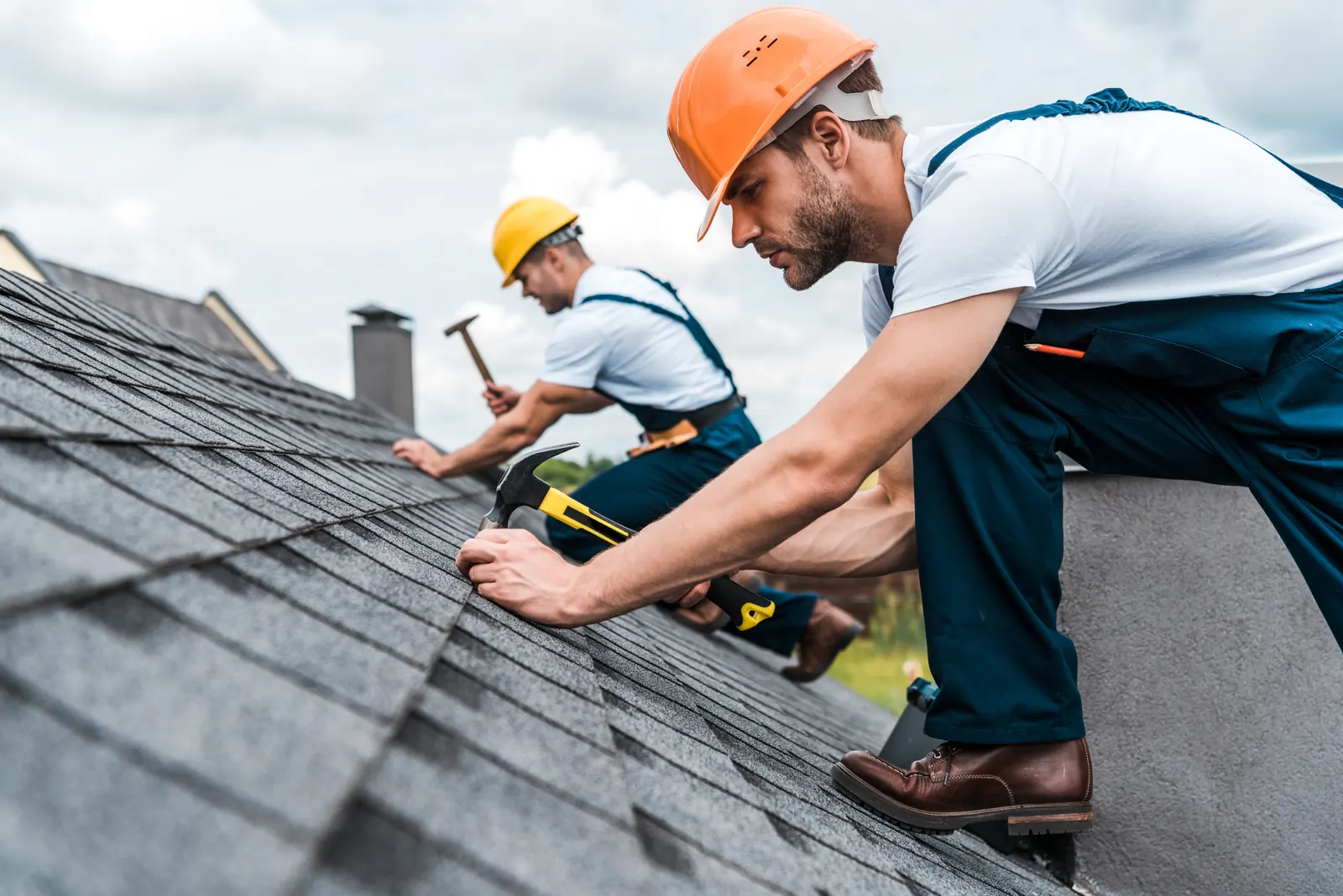 Roofers inspecting and maintaining a shingle roof in Toronto